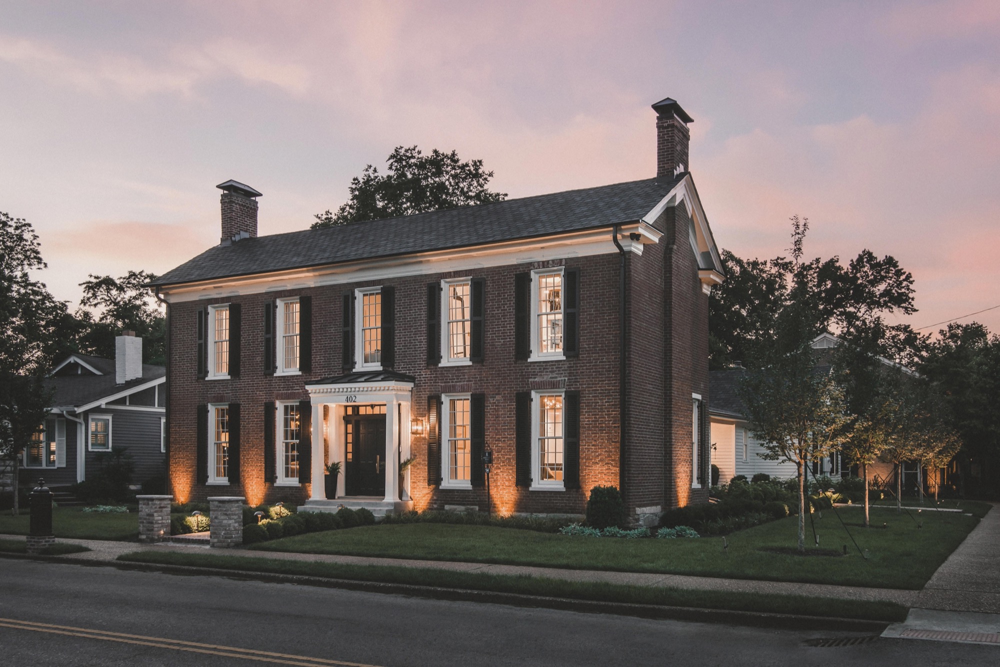 Exterior photo of brick home at dusk